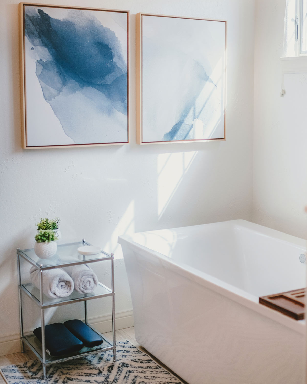 A lovely bathroom with paintings and a bathtub
