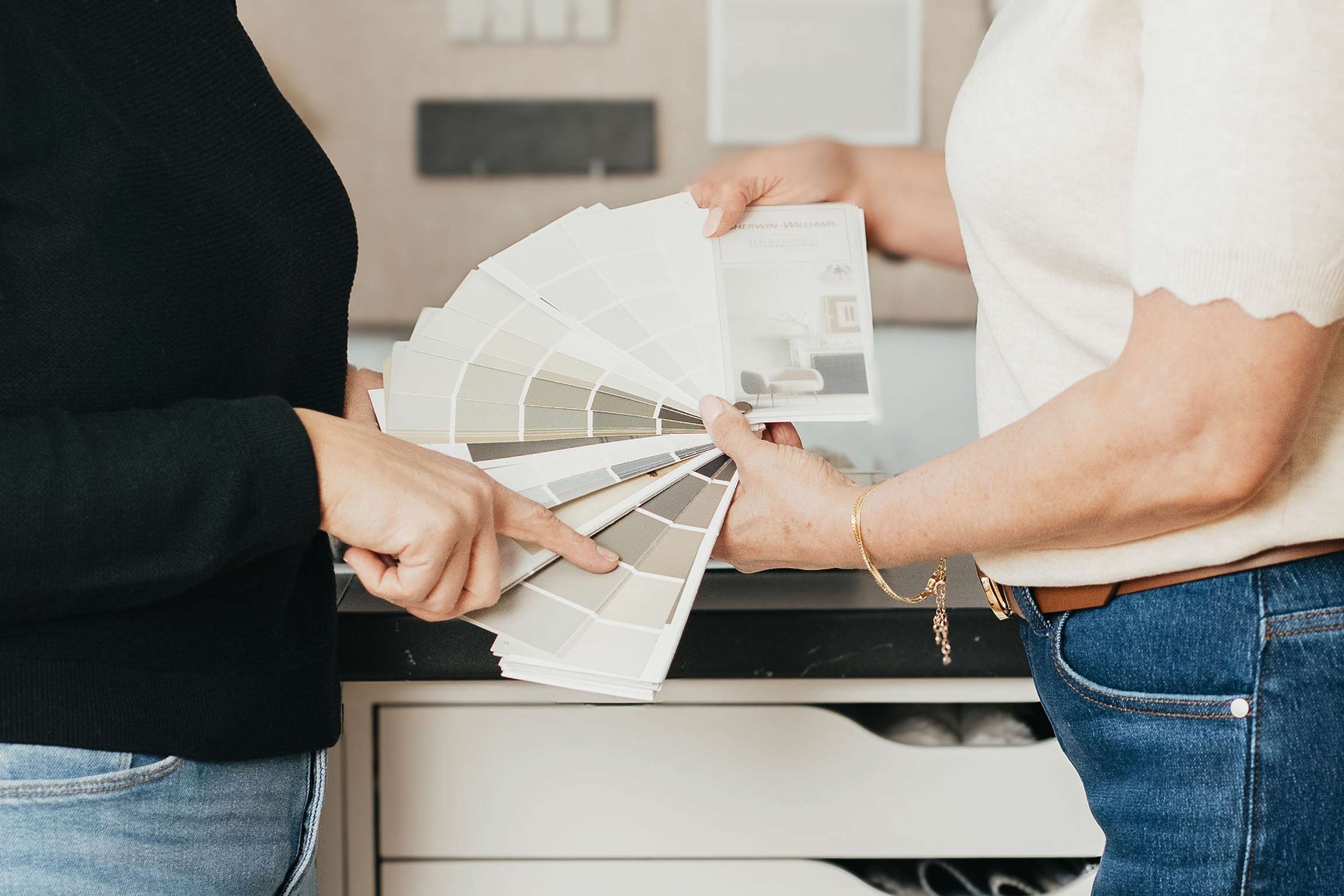 Two desginers looking at different color combinations
